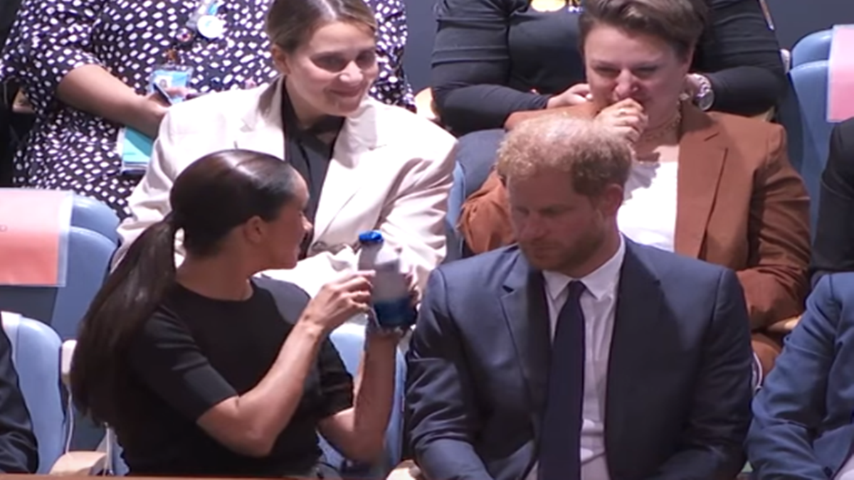 Meghan Markle passes water to coughing woman